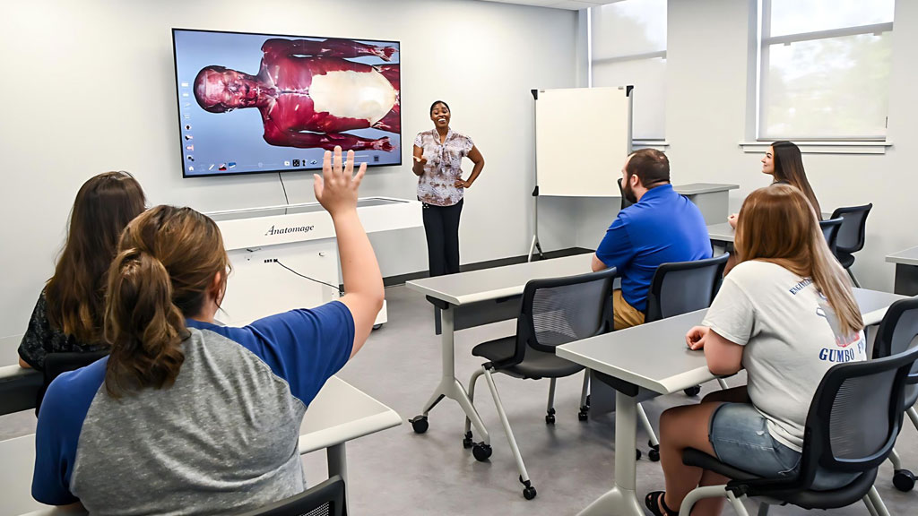 A professor engages students with the Anatomage Table, leveraging its interactive 3D anatomy technology to deliver an immersive and hands-on learning experience.