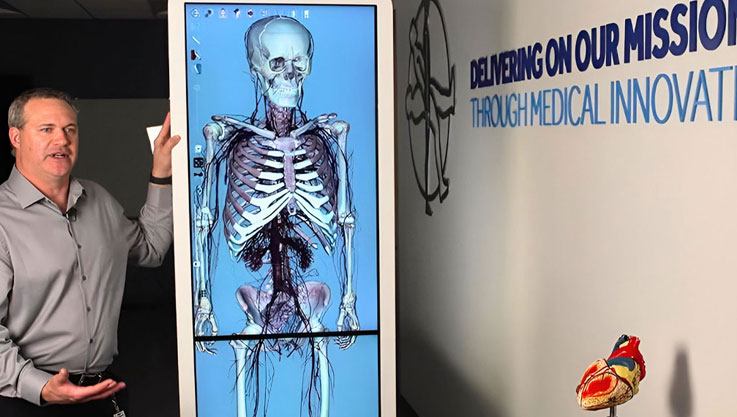 Educator showcasing Anatomage's virtual cadavers for surgical training.