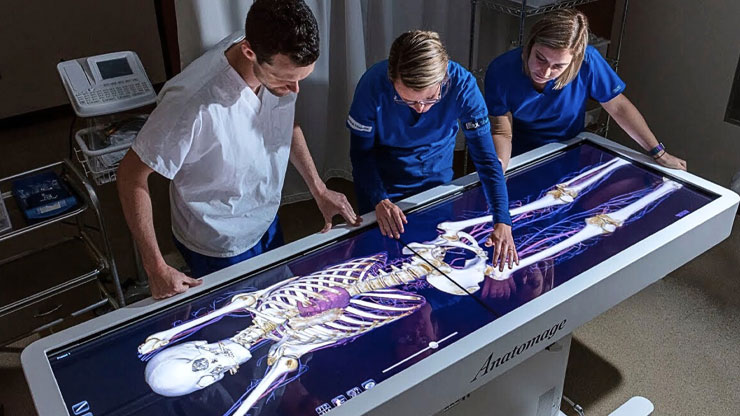 Medical staff using the Anatomage Table to support patient communication through 3D anatomy visualizations.