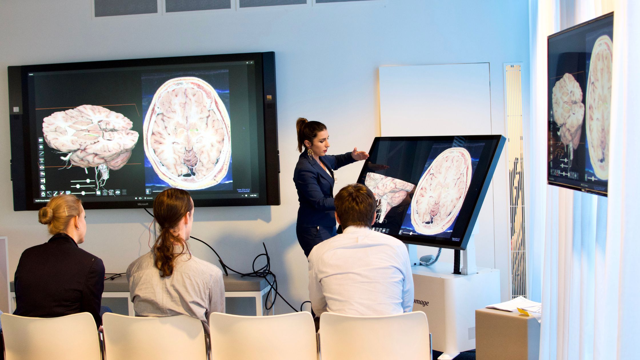 Instructor demonstrating advanced clinical technology on the Anatomage Table, using 3D visualizations of human anatomy to support the anatomy curriculum and improve medical training.