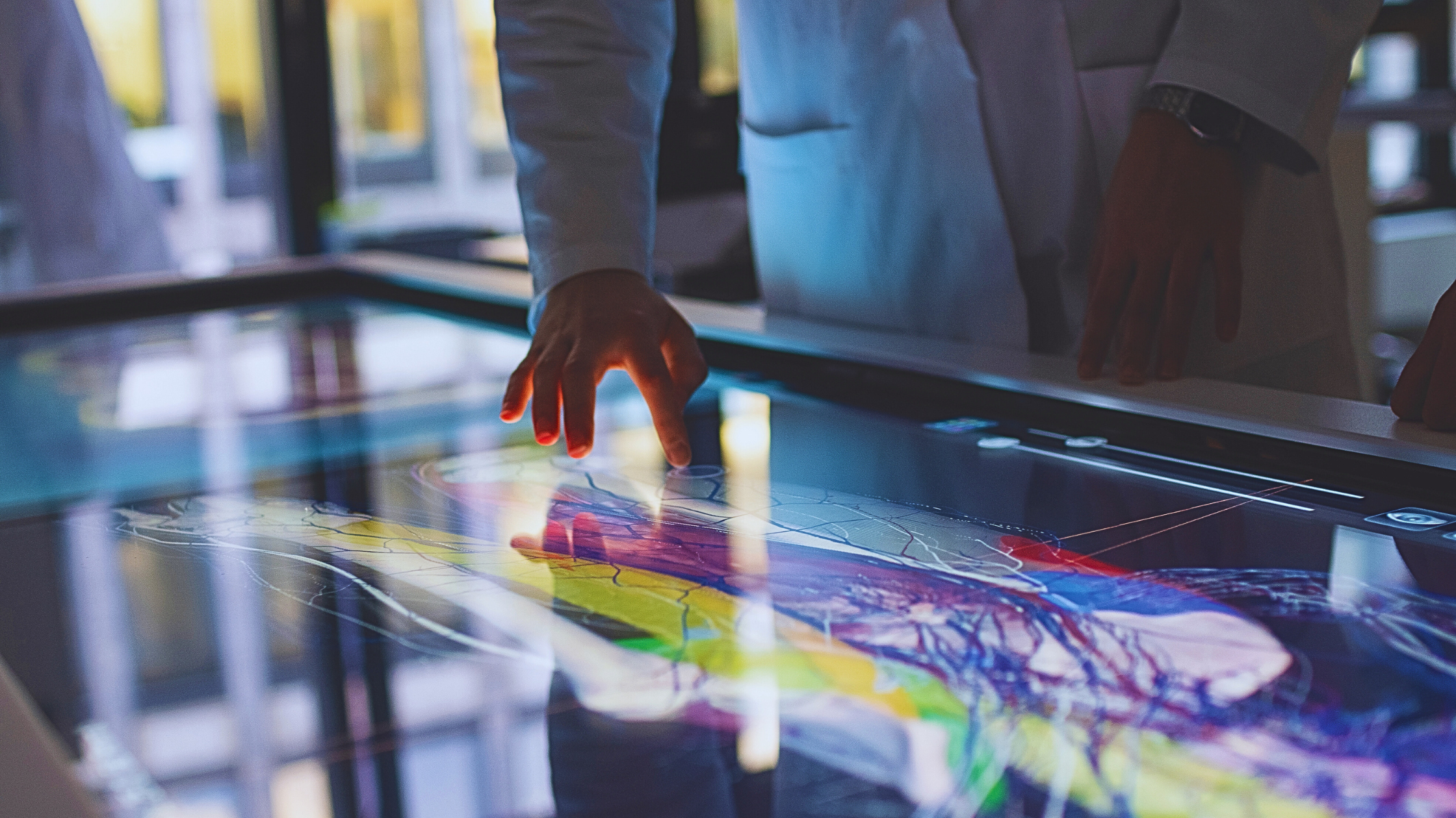 Medical professionals interacting with Anatomage’s touchscreen medical software to study detailed human anatomy through 3D visualization.