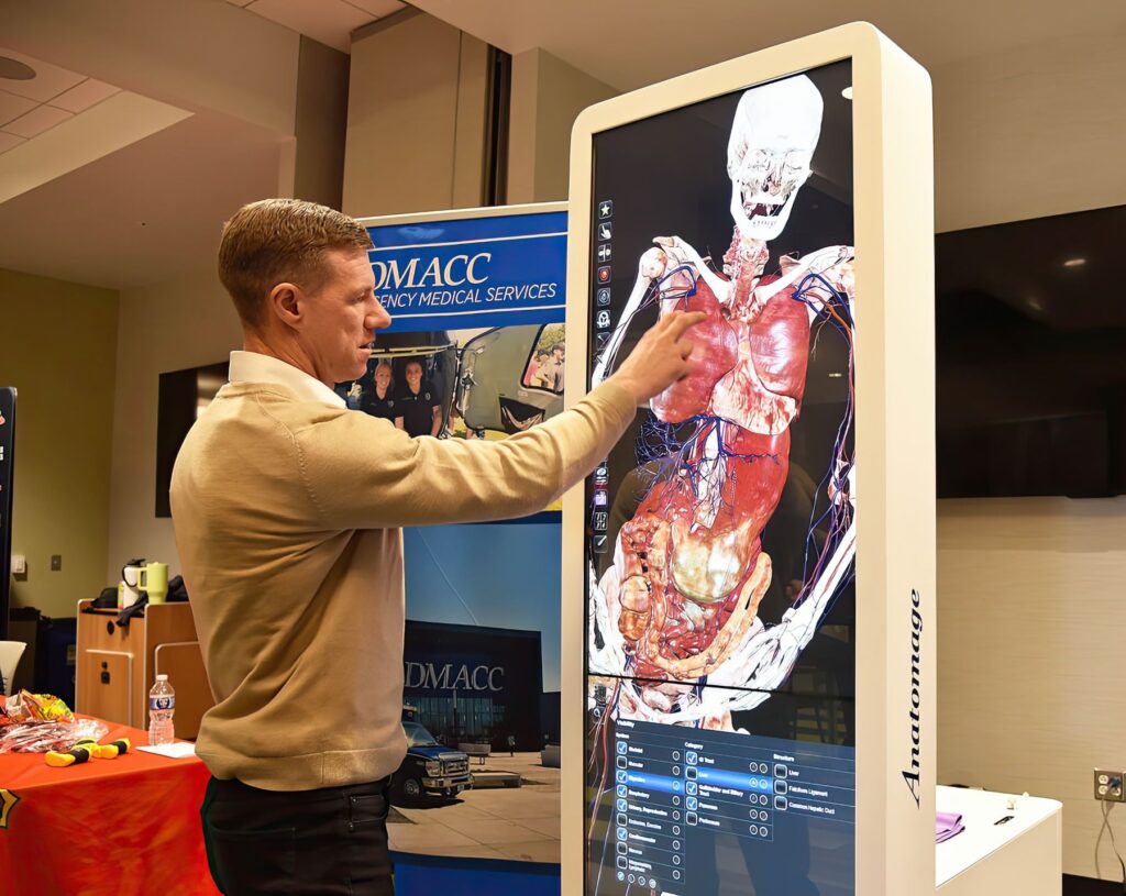 Instructor demonstrating how to use the Anatomage Table Convertible.