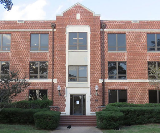 An academic building at Prairie View A&M University, featuring large windows and landscaped bushes, part of the campus’s educational facilities.