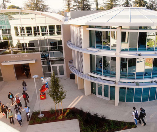 Students walking outside Nichols Hall at The Harker School campus, featuring modern glass architecture, used for high school education and STEM learning.