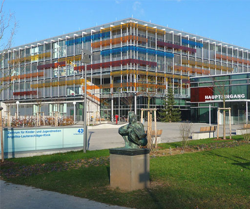 Front view of University of Heidelberg Medical School building with colorful glass facade and entrance sign, featuring modern architecture for medical education in Germany.