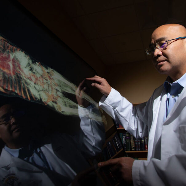 Orange County Medical Examiner interacting with the Anatomage Table Clinical.