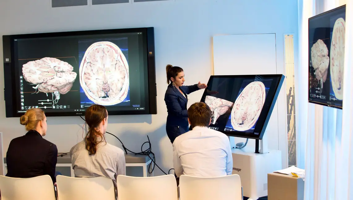 Instructor demonstrating advanced clinical technology on the Anatomage Table, using 3D visualizations of human anatomy to support the anatomy curriculum and improve medical training.