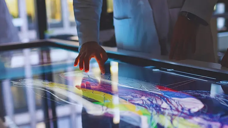 Medical professionals interacting with Anatomage’s touchscreen medical software to study detailed human anatomy through 3D visualization.