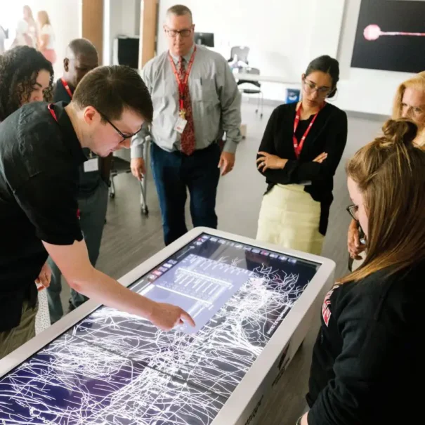A group of students exploring the Anatomage Table.
