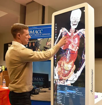 Instructor demonstrating how to use the Anatomage Table Convertible.