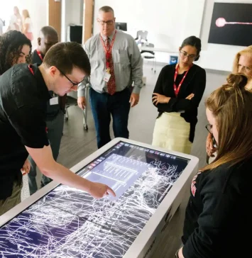 A group of students exploring the Anatomage Table.