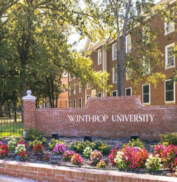 Entrance sign of Winthrop University with red brick landscaping and flower beds in front of campus academic buildings, where students take anatomy and physiology courses as part of their health science education.